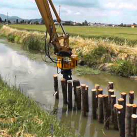 Enfoncer des pieux dans la rivière avec une pelle hydraulique